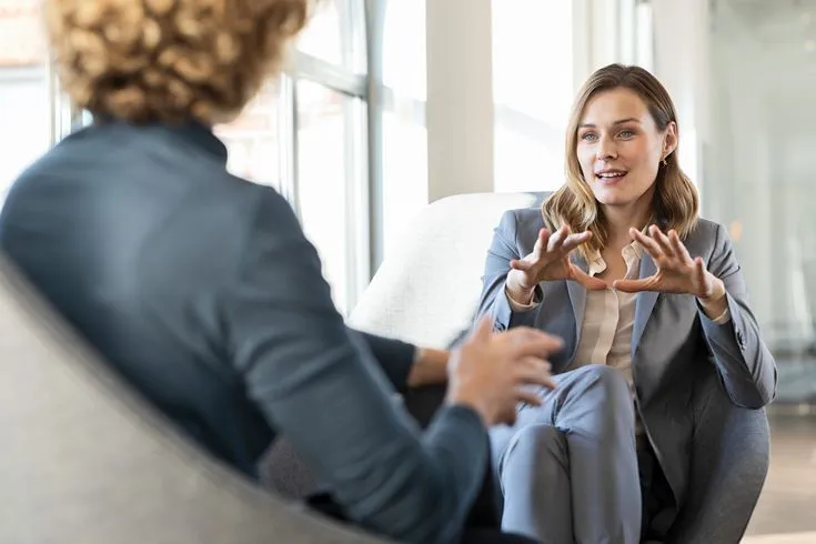 An HR consultation between two colleagues in an office